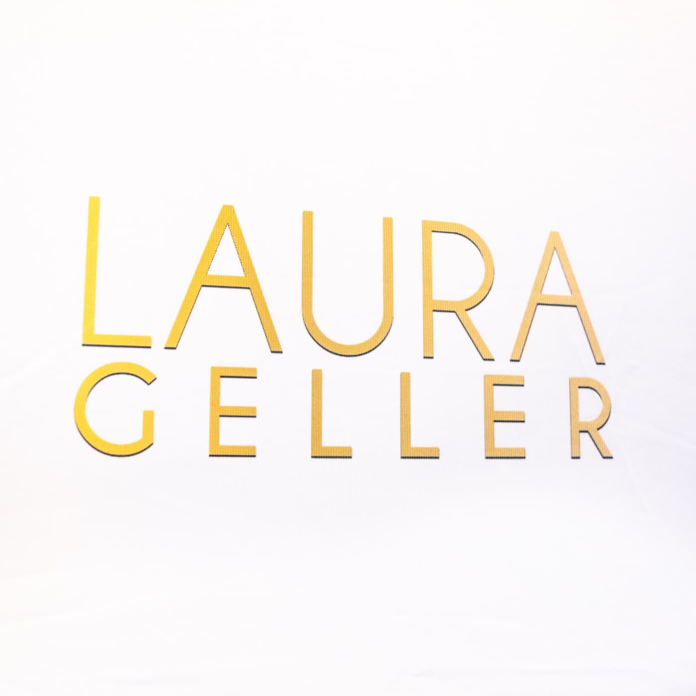 Gold Laura Geller logo wall built for a branded photo activation.