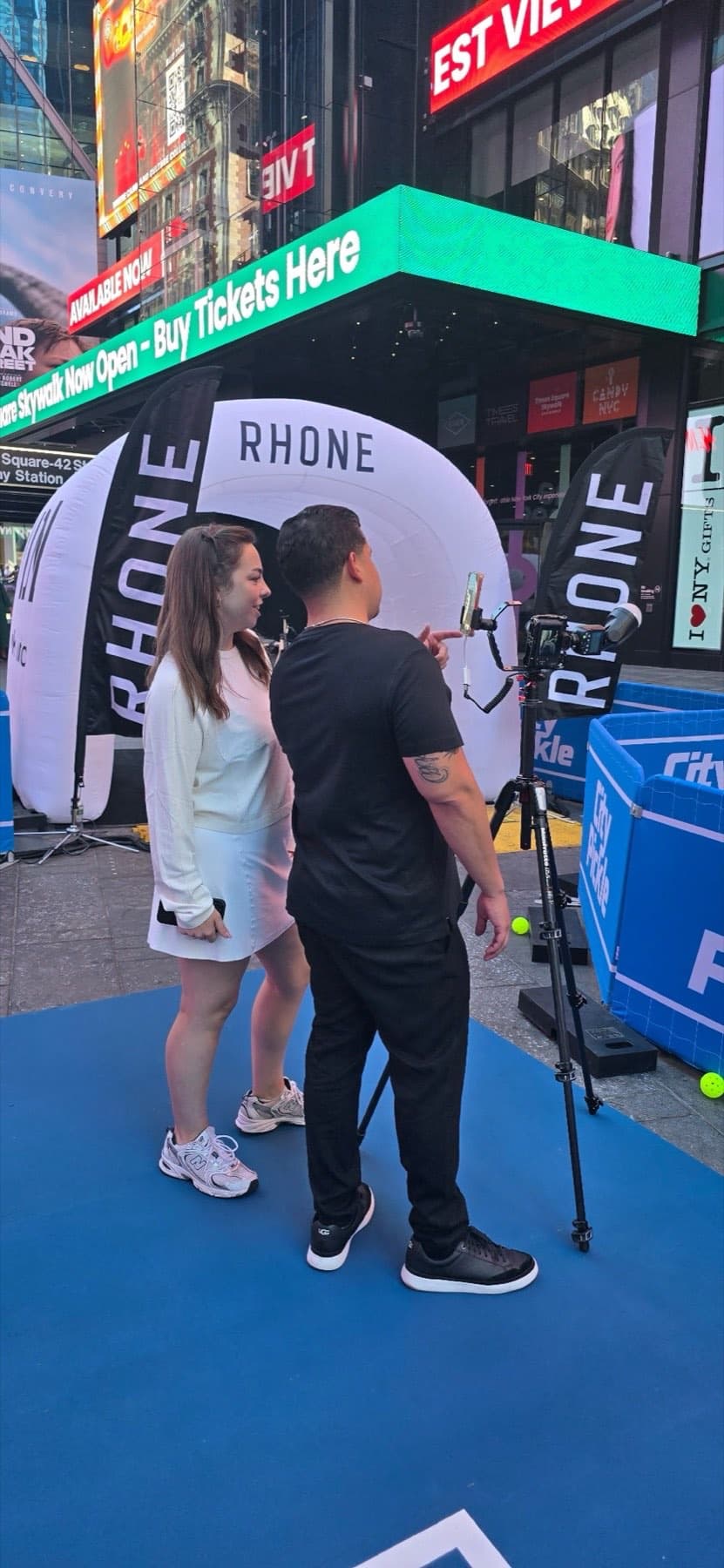 A DigiGroup roaming photographer and iPad share attendant capturing a guest's photo in front of the Rhone tunnel.