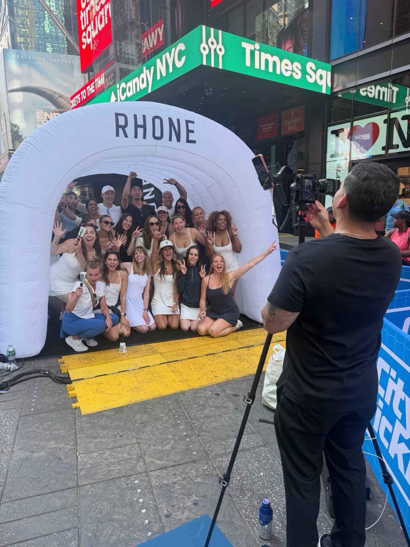 Behind-the-scenes view of the DigiGroup crew photographing a large group at the Rhone activation in Times Square.