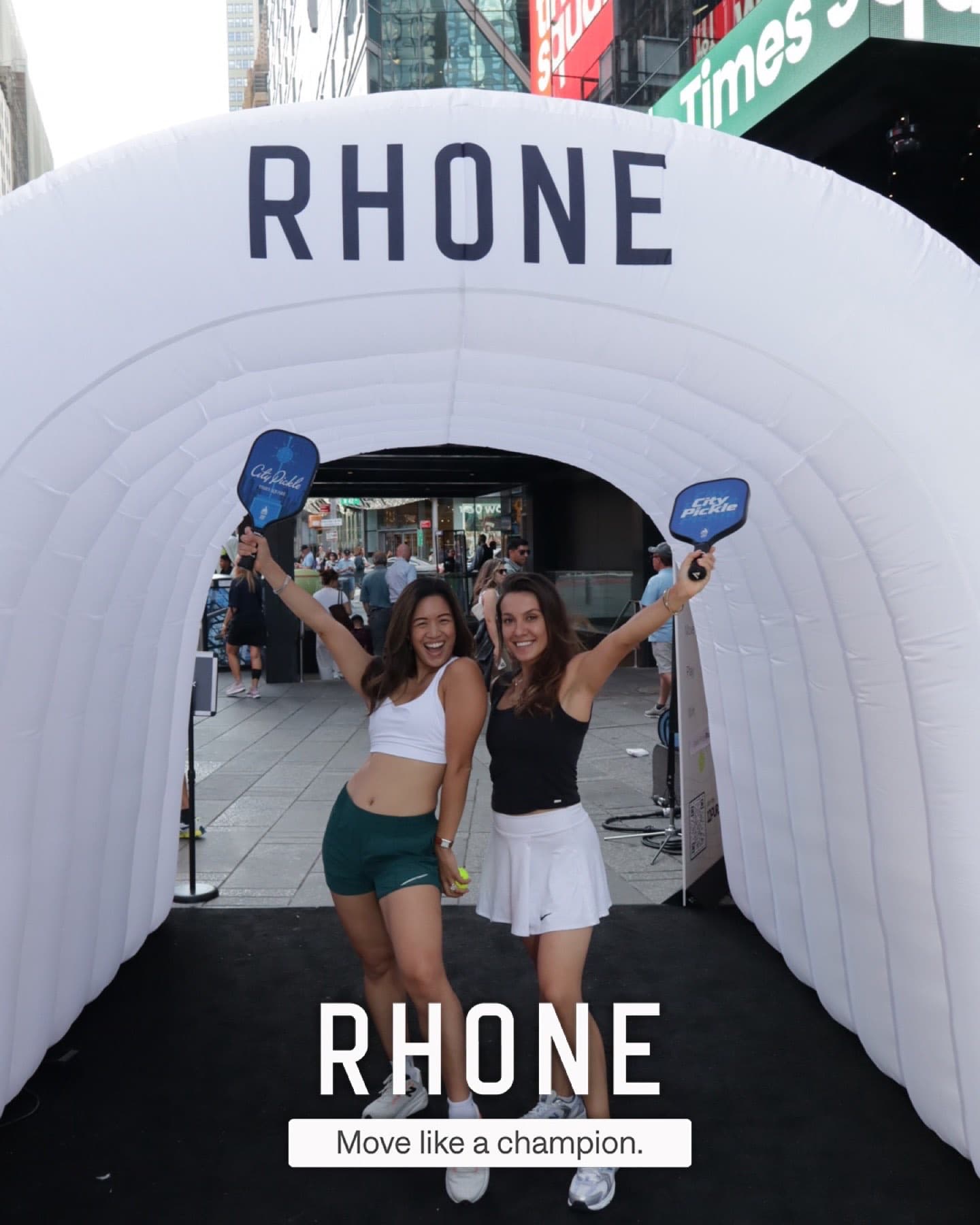 Two guests raise City Pickle paddles inside the Rhone tunnel at CityPicklePalooza.