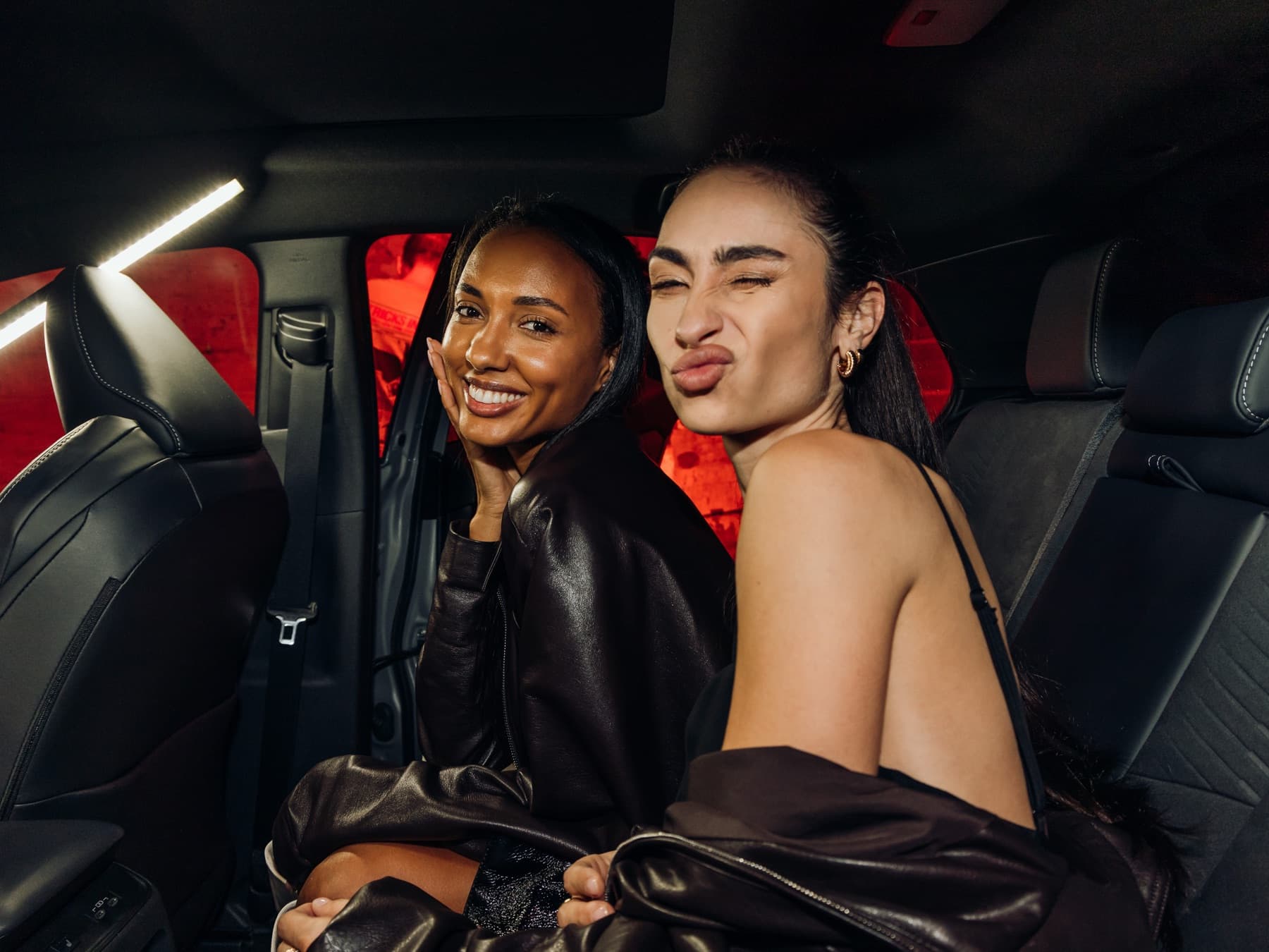 Two guests seated inside a Toyota C-HR at the Hypebeast NYFW party, framed by the in-car camera rig used to capture and livestream the moment.