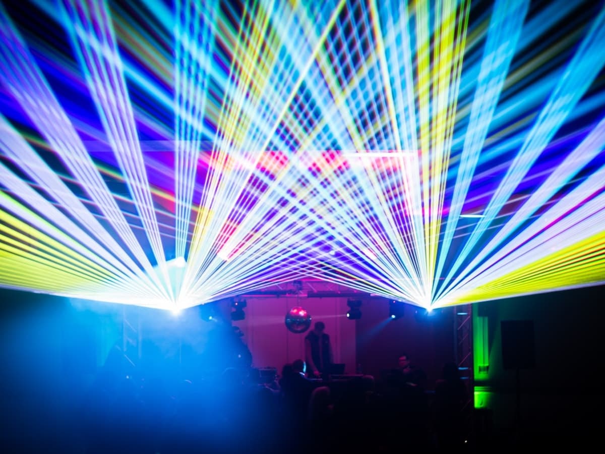 Blue and white laser burst over a crowd, run from DigiTron show control.