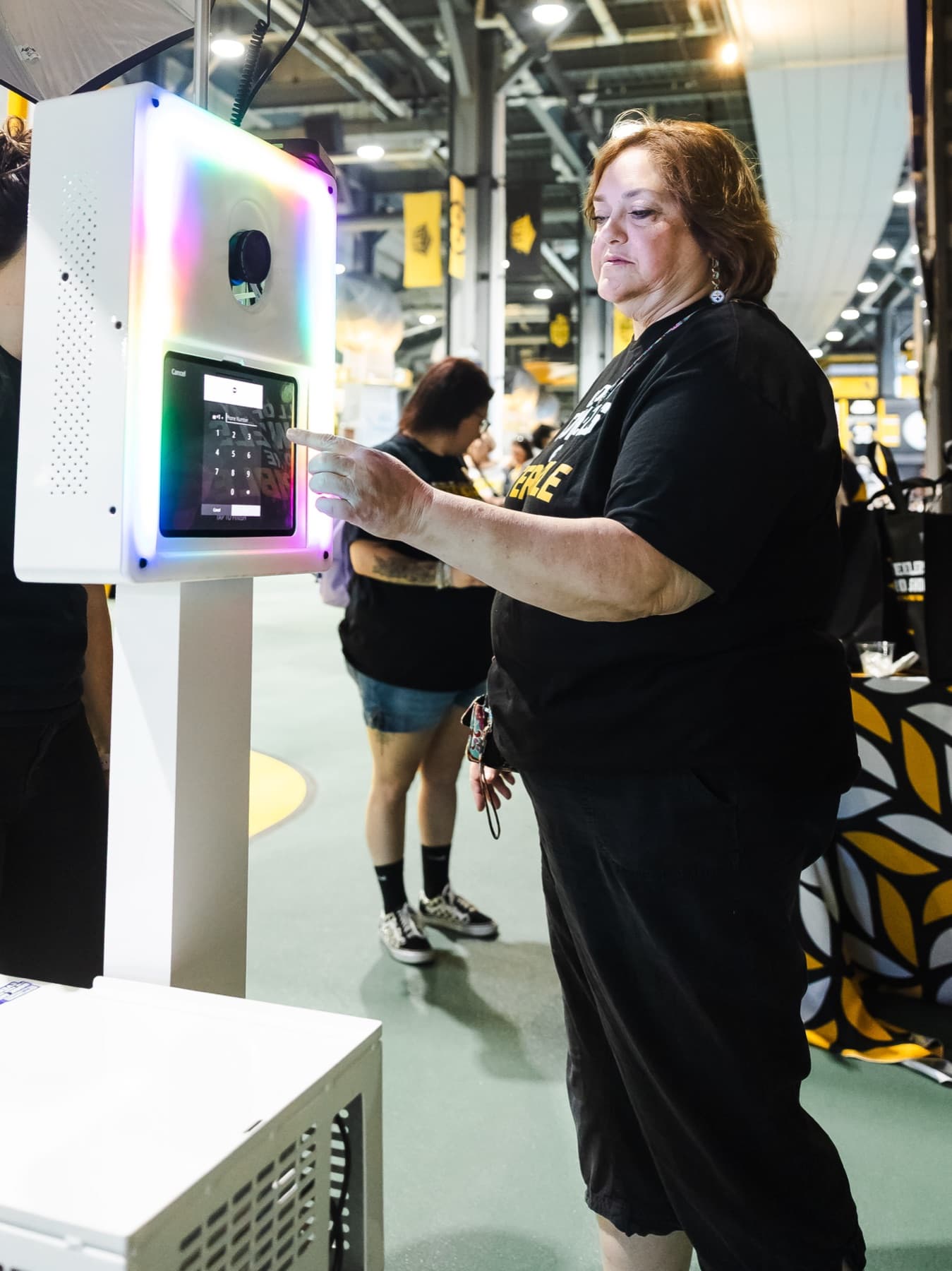 DigiGroup crew member running a capture kiosk on the activation floor.