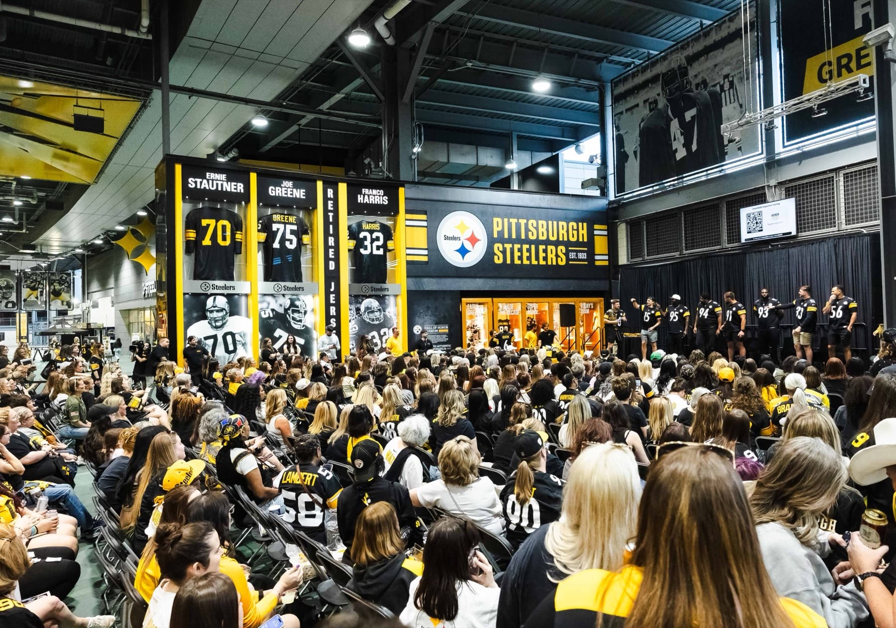Wide view of the Steelers Draft Party crowd under the Great Hall banners.